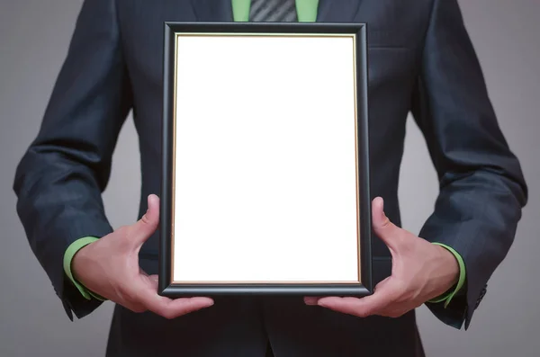Boş diploma veya sertifika işadamı elinde alay etmek yukarıya. Kopya alanı ile boş fotoğraf çerçevesi kenarlığı.