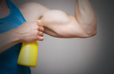 İzole üzerinde gri arka plan büyümeye bir anabolik steroid elinde püskürtme yoluyla pazı üzerinde uygulama komik atletik adam.