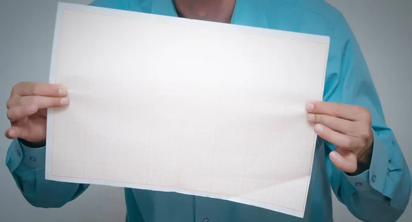 Man is holding in hand a plan draft document isolated on gray background.