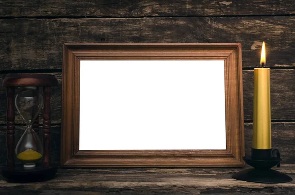 Empty Photo Frame Sand Watch Burning Candle Aged Wooden Table — Stock Photo, Image