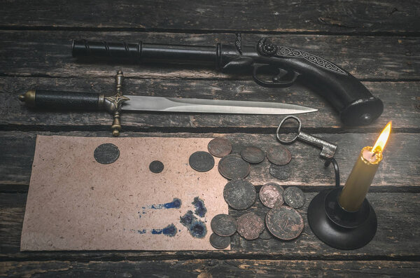 Blank page document, weapon, money and burning candle on the wooden desk table. Compromising evidence.