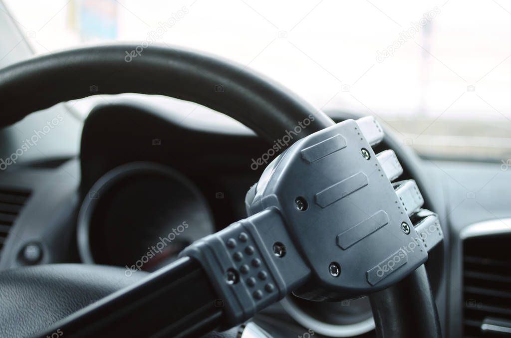 Robot hand on the car steering wheel. Robot pilot is driving a car concept.