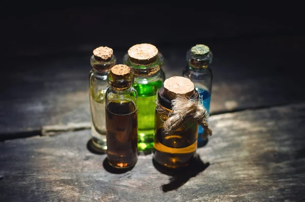 桌上的瓶子里的各种魔术药水或五颜六色的精油 — 图库照片