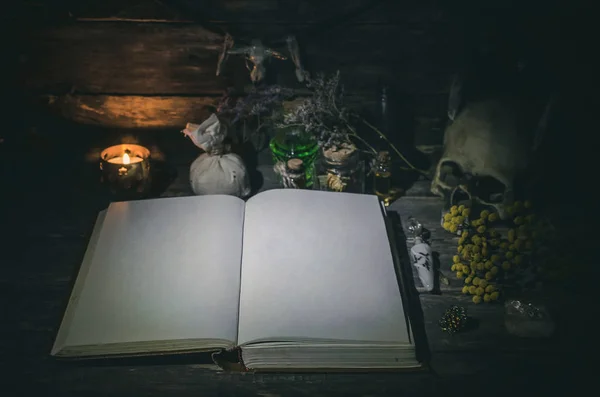 Open book of magic with blank pages on magician table background. The spell book.