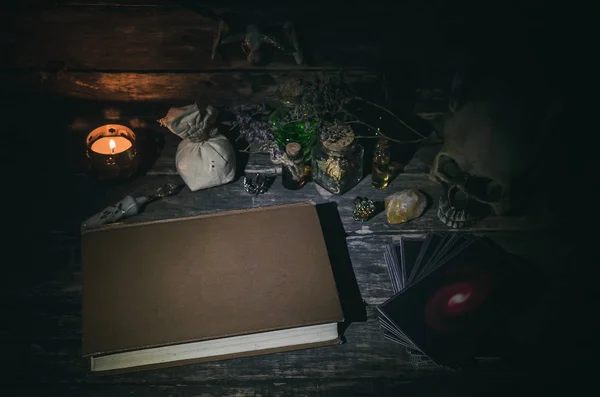 Tarot cards and book of magic on magic table background.