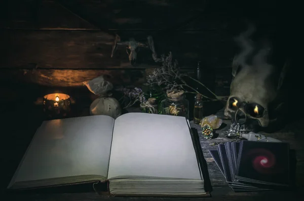 Tarot cards and book of magic on magic table background.