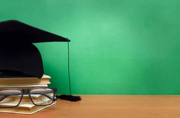 Pilha Livros Óculos Boné Formatura Fundo Conselho Escolar Verde Volta — Fotografia de Stock