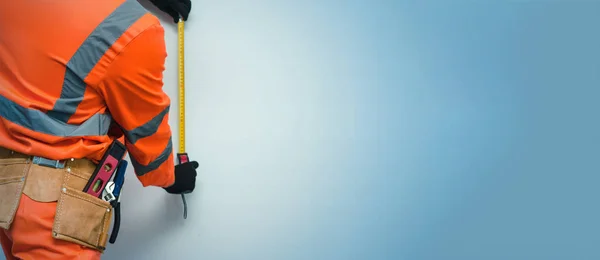 Builder Worker Makes Measurement Building Tape Isolated Blue Background Copy — Stock Photo, Image