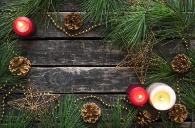 Noel ve yeni yıl düz arka plan kopya alanı ile yatıyordu. Köknar ağacı dalları, yanan mumlar ve altın koni üzerinde ahşap arka plan yaş arası.
