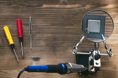 Retro bilgisayar Cpu çipi Büyüteç aracılığıyla lehimleme stand ve havya teknisyen mühendis tablo zemin kopya alanı üzerine monte. 