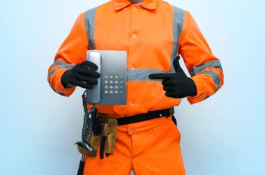 Oluşturucu işçi bir ahize telefon elinde tutuyor. Bir tamirci kavram ara. Bize ulaşın.