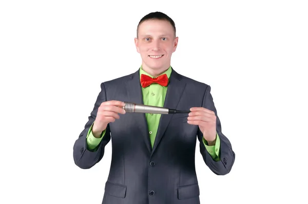 Happy presenter or television host with microphone in the hands isolated on the white background.