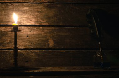 Quill'in kalem inkpot ve yazar Resepsiyon Masa artalanını kopya alanı ile yanan mum. Eğitim kavramı.