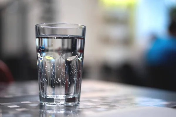 stock image Glass of cold mineral water on the table.