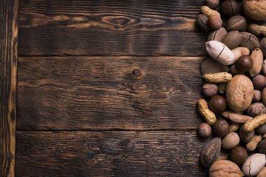 Kenarlık çerçeve fındık kahverengi ahşap tahta arka plan üzerinde çeşitli tür kopya alanı ile.