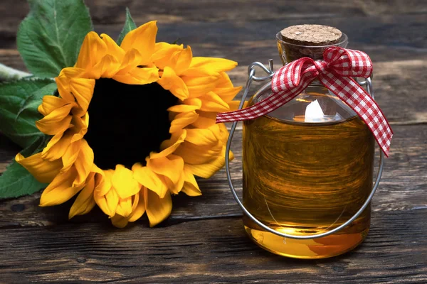 Sunflower oil in the bottle on the wooden table background.