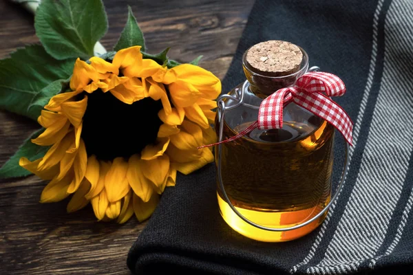 Sunflower oil in the bottle on the wooden table background.