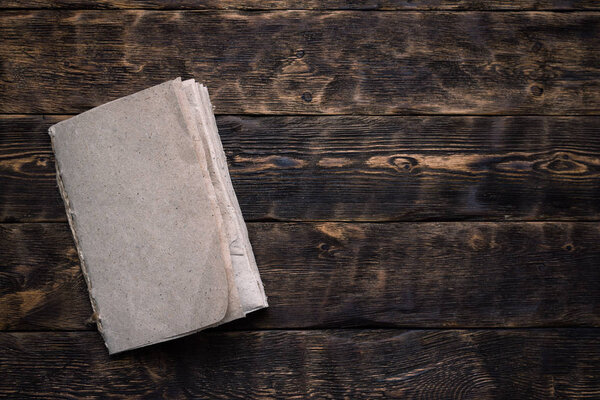 Blank paper page on a wooden board background. Agreement mockup.