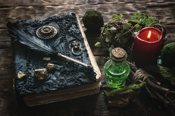 Spell book, magic potion and other various witchcraft accessories on the wizard table background.