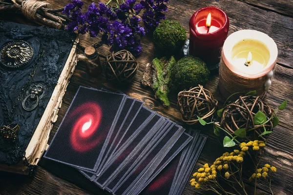 Tarot cards and book of magic on a wooden table background. Future reading.