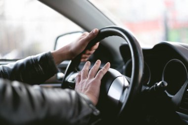 Angry driver is honking and is yelling by sitting of a steering wheel. Road aggression concept. Traffic jam. clipart