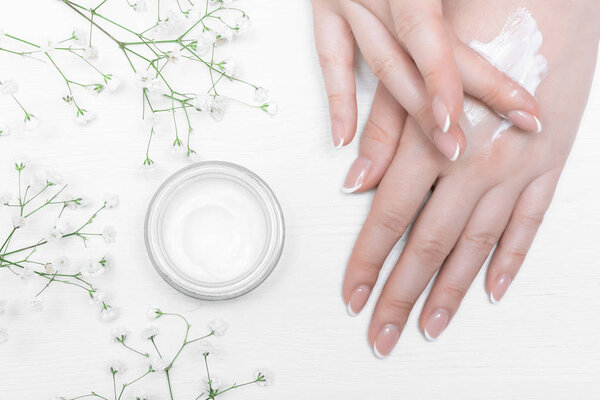 Cosmetic natural cream in a jar on a white table background.