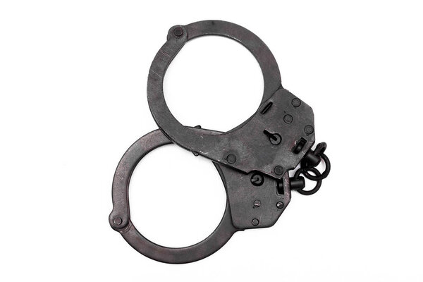 Black handcuffs isolated on the white background.