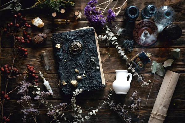 Magic recipe book and a magic potions on a table. Witchcraft background with copy space. Druid or witch doctor table.