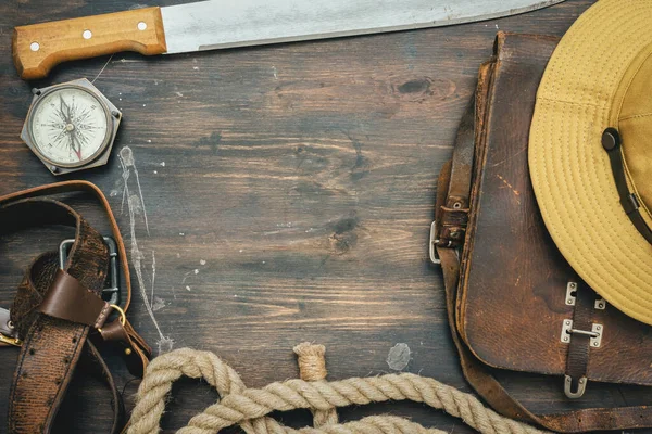 Old travel equipment on the wooden table flat lay background.