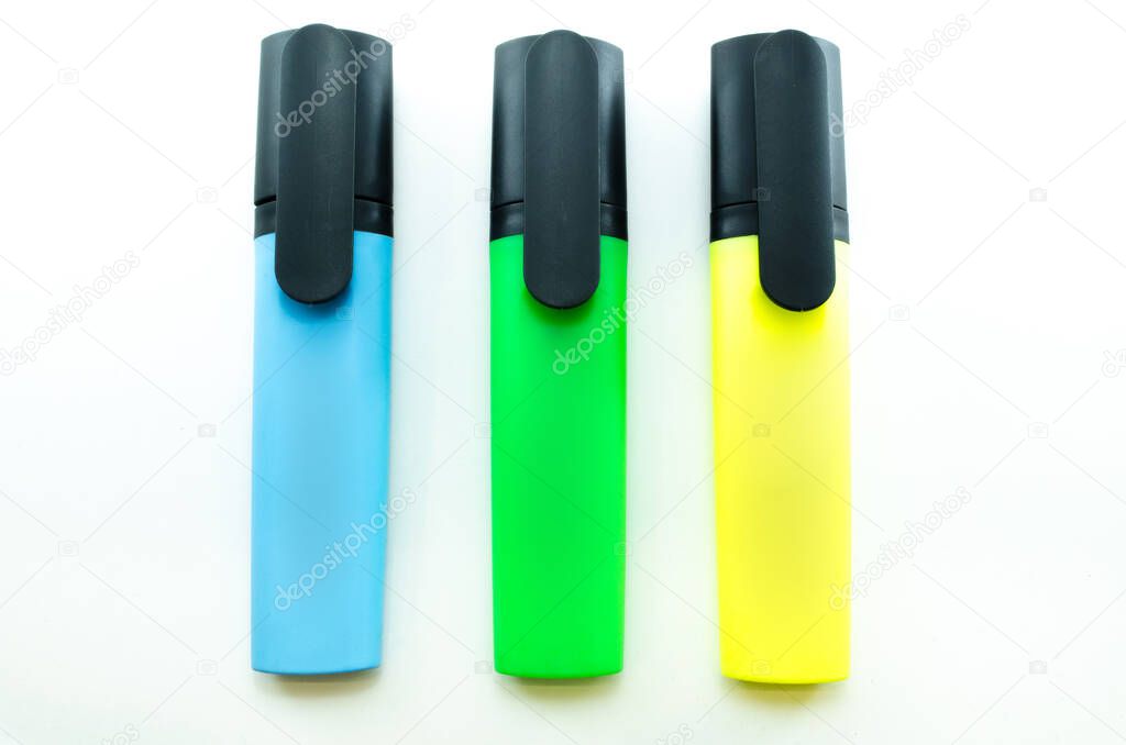 Markers isolated on white background. Blue, green and yellow highlighters lays in line.