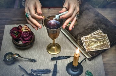 Woman witch prepare a magic potion. Future reading. Tarot cards on fortune teller desk table. clipart