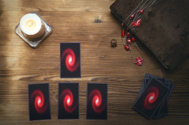 Tarot kartları destesi ve falcı masasının arkasındaki büyü kitabı. Gelecek okuma konsepti.