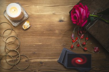 Falcı masasında tarot kartları ve büyü kitabı var. Kehanet kavramını seviyorum.