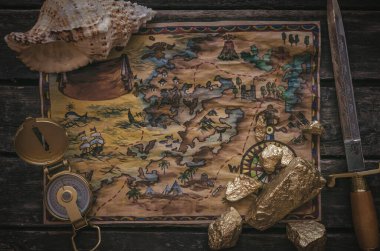 Hazine haritası, pusula ve altın külçesi ahşap masa arkasında..