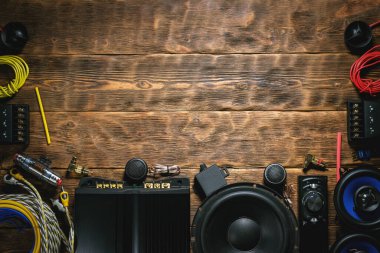 Kahverengi ahşap çalışma arka planında fotokopi alanı olan yeni bir araba ses ekipmanı.