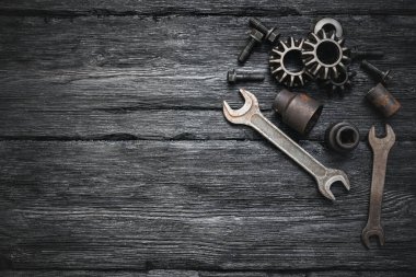 Siyah düz tezgah arka planında kopyalanmış çarklar, fındıklar ve anahtarlar.