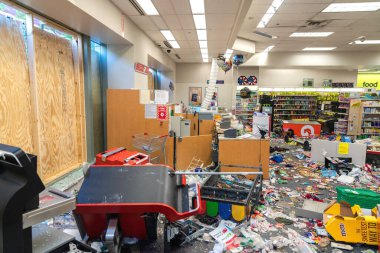 CHICAGO, ILLINOIS - MAY 31, 2019: CVS Pharmacy store interior destroyed by the protesters after nights of riots, looting and chaos in Downtown Chicago. Broken windows and debris on the floor clipart