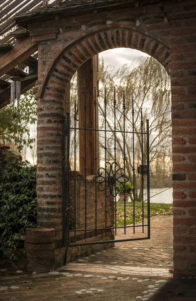 Small Door Open Passage Brick Wrought Iron Evocative Emotional Image — Stock Photo, Image