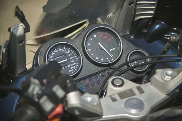 speedometer of a modern enduro bike, detail of the instrument cluster with a handlebars.