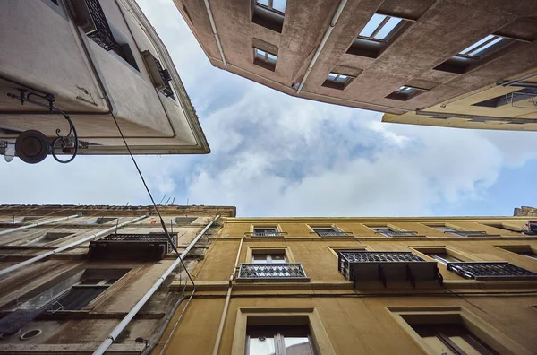 profile of some historical buildings taken from below under a cloudy sky.