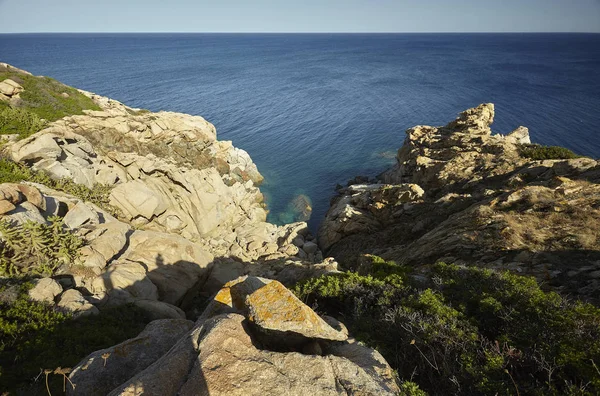 Coastline of Capo Ferrato with a precipice overlooking the sea formed by granite rocks typical of these areas.