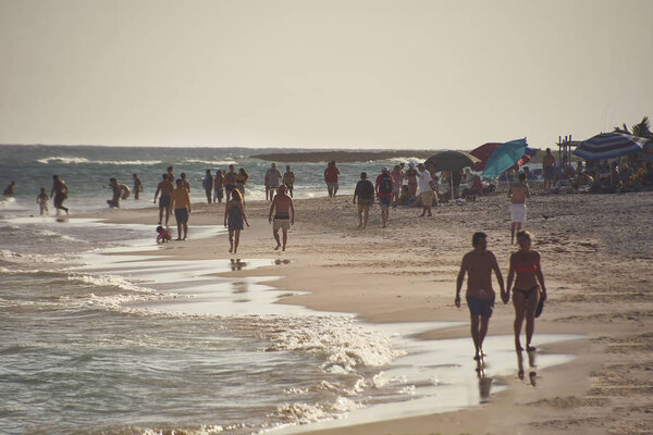 View at dusk of a foreshortening of the beach of xpu-Ha iin messico bathers at dusk.