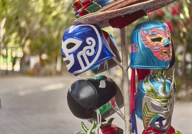 Some Mexican masks on display at a market in Tulum. clipart