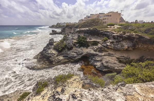 Magnificent cliff on the sea with houses built right above it. Panorama of Isla Mujeres in Mexico