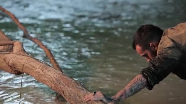 男の子は川の岸に自分自身をドラッグ2 — ストック動画
