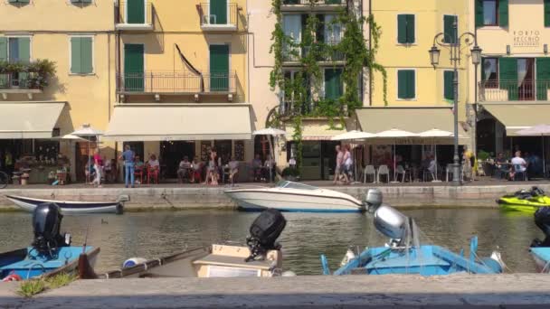 Dogana Veneta e Porticciolo em Lazise, na Itália com barcos coloridos 5 — Vídeo de Stock