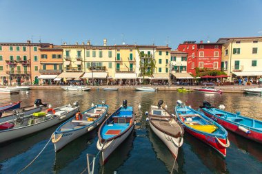 LAZISE, İTALYA 16 Eylül 2020: Lazise 'de Dogana Veneta ve Porticciolo, renkli botlarla