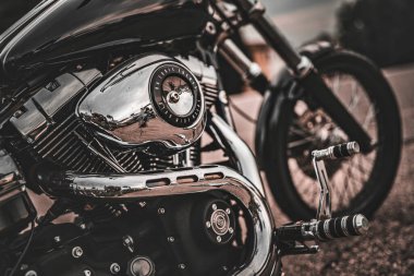 Milan, İtalya 20 Eylül 2025: Harley-Davidson v-çift motorlu ve egzoz boruları cilalanmış krom yüzeyleri gösteriyor, yolu ve gökyüzünü yansıtıyor, açık bir yolda özgürlük ve klasik tarzı aktarıyor.