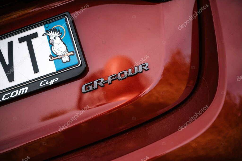 Milan, italy 20 september 2025: red toyota gr yaris rear close-up showing gr-four badge, awd detail, metallic paint and license plate with cockatoo sticker