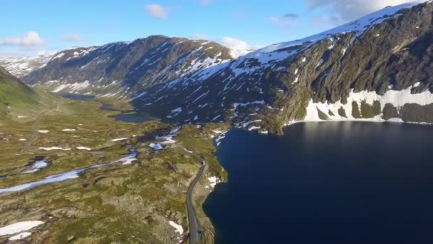 ノルウェーの湖畔の山道を走るバスの航空写真 美しい風景とスカンジナビアの旅 — ストック動画